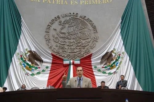 Mexican government chamber with a national flag behind a podium