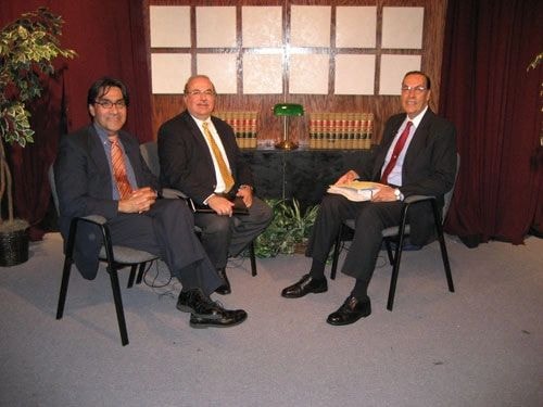 Dr. Roberto Rosas seated with colleagues at a formal meeting